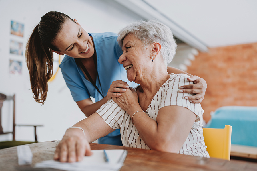 A nurse and an older adult A nurse and an older adult