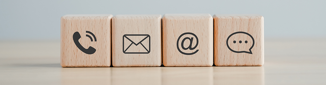 Blocks with icons for a phone, letter, @ symbol and speech bubble on Blocks with icons for a phone, letter, @ symbol and speech bubble on